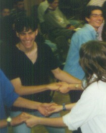laughing teenagers holding hands